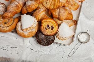 Collection of cakes and different pies with cheese, apple, cherry, meat and cabbage on a plate. Bakery goods. Sweet pastries. photo