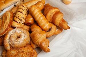 Collection of cakes and different pies with cheese, apple, cherry, meat and cabbage on a plate. Bakery goods. Sweet pastries. photo
