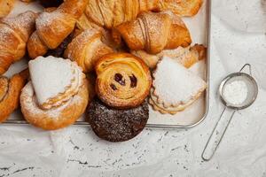 Collection of cakes and different pies with cheese, apple, cherry, meat and cabbage on a plate. Bakery goods. Sweet pastries. photo