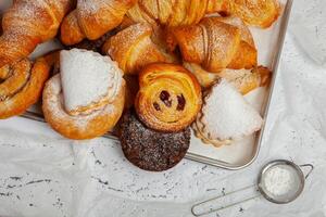 Collection of cakes and different pies with cheese, apple, cherry, meat and cabbage on a plate. Bakery goods. Sweet pastries. photo