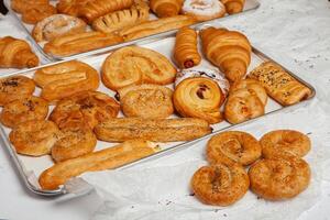 Collection of cakes and different pies with cheese, apple, cherry, meat and cabbage on a plate. Bakery goods. Sweet pastries. photo