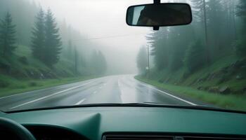 car driving on a highway, raining and misty photo