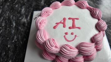 White cake with pink icing, decorated with AI and a smiley face, being cut, perfect for summer birthdays or celebrations video