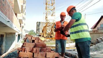 Builders Are Loading Bricks. Male Workers Sort Through The Disassembly Of Bricks video