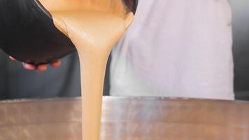 The baker adds leaven from yeast to the dough. Kneading the dough at the bakery. video
