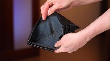 woman opens an empty wallet. there is no money in the wallet. video