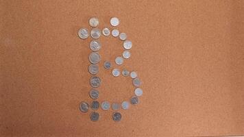 stop motion animation of a bitcoin symbol made up of coins. cryptocurrency video