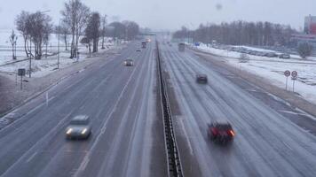 timelapse cars driving fast along wide highway with white stripes on winter video