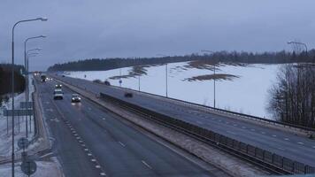 timelapse of movement of cars and vehicles on a winter evening along the highway video