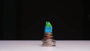 stop motion animation house rises on a stack of coins. the stack of coins grows video