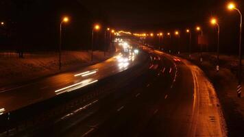 timelapse of cars moving along a night winter highway. Evening heavy traffic video