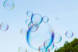 soap bubbles against the sky, reflection of the sun in the bubbles, color play, abstraction photo