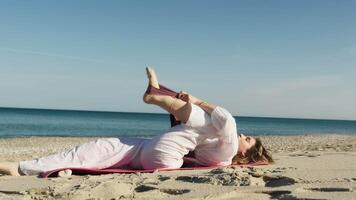 Ballerina Makes Leg Movements On The Beach Near The Ocean In Summer video