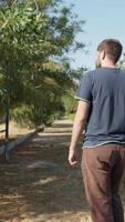 Man Talks On The Phone While Walking In A Park video