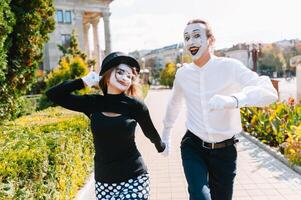 A couple of merry mimes. He hurries on a date. photo