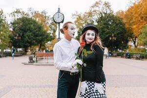 A couple of merry mimes. He hurries on a date. photo