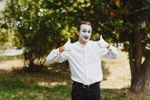 young Funny mime shows something. photo