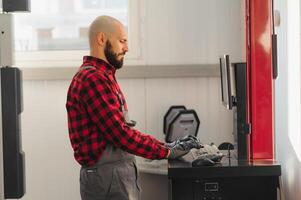 working process of a full system diagnostic scanner that can quickly test every system module s status and make faster diagnosis. mechanic makes computer diagnostics of the car photo