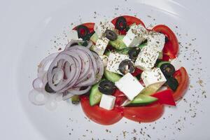 Fresh salad with vegetables and cheese on a white background photo
