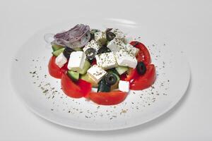 Fresh salad with vegetables and cheese on a white background photo