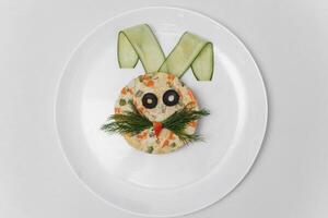 baby salad laid out in the form of a bunny on the plate photo