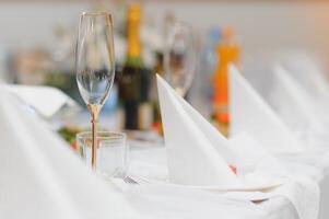 Glasses on the festive table setting. Wedding table decor concept. Table setting in classic style, setout. fine art. photo