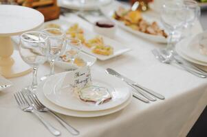 Glasses on the festive table setting. Wedding table decor concept. Table setting in classic style, setout. fine art. photo