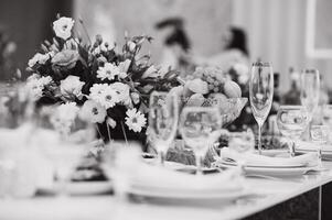 Glasses on the festive table setting. Wedding table decor concept. Table setting in classic style, setout. fine art. photo