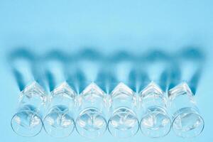 Glasses of water on blue. Close up. Copy space. Water balance for healthy and detox. photo