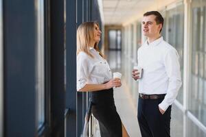 Smiling work team during break time in bright office photo