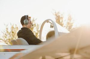 Young pilot is preparing for take off with private plane. photo