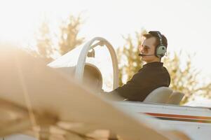 Young pilot is preparing for take off with private plane. photo