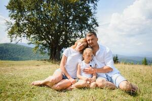 Young family with child resting on a mountain. vacation in the national park photo