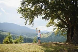 Small Boy Playing with Toy Airplane photo