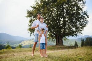 Young family with child resting on a mountain. vacation in the national park photo