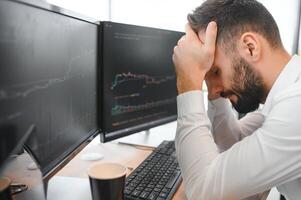Stressed business man crypto trader broker investor analyzing stock exchange market crypto trading decreasing chart data fall down loss, desperate about losing money of crisis, recession, inflation photo