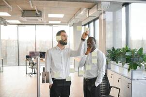 Corporate, sticky notes and business people planning a team mission, project or growth of business plan photo