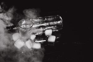 Vodka. Shots, glasses with vodka with ice .Dark background. Copy space .Selective focus. photo