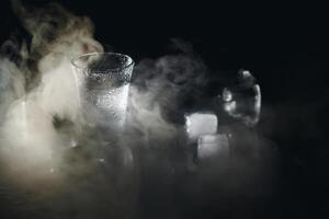 Vodka. Shots, glasses with vodka with ice .Dark background. Copy space .Selective focus. photo