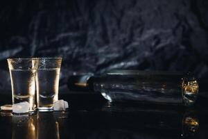 Vodka. Shots, glasses with vodka with ice .Dark background. Copy space .Selective focus. photo