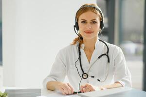 doctor talking with sick person through laptop online system and using mobile digital tablet computer searching patient medical records on the database files document photo