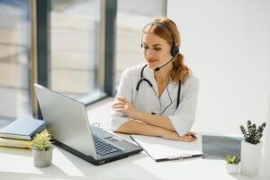doctor talking with sick person through laptop online system and using mobile digital tablet computer searching patient medical records on the database files document photo