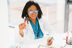 portrait of african female doctor at workplace. photo