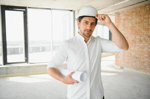 Close up engineers working on a building site holding a blueprints.Engineering and architecture concept photo