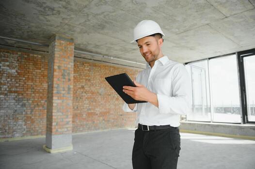 Close up engineers working on a building site holding a blueprints.Engineering and architecture concept photo