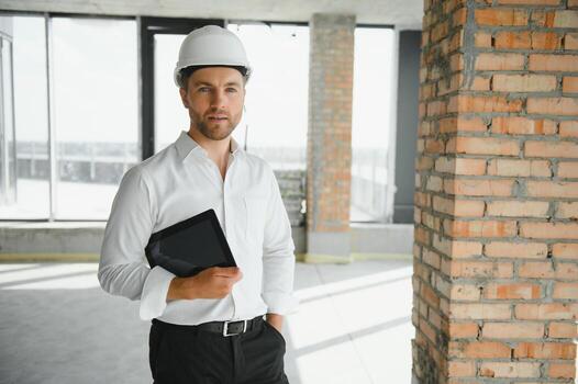 Close up engineers working on a building site holding a blueprints.Engineering and architecture concept photo