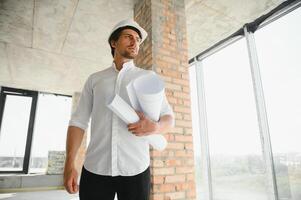 Close up engineers working on a building site holding a blueprints.Engineering and architecture concept photo