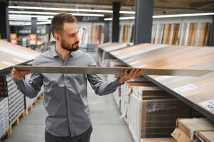 Man choosing flooring in hardware store photo