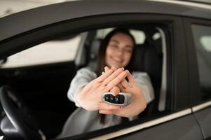 Beautiful young female client customer choosing new car photo