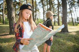 Little boy and girl go hiking on a forest road photo